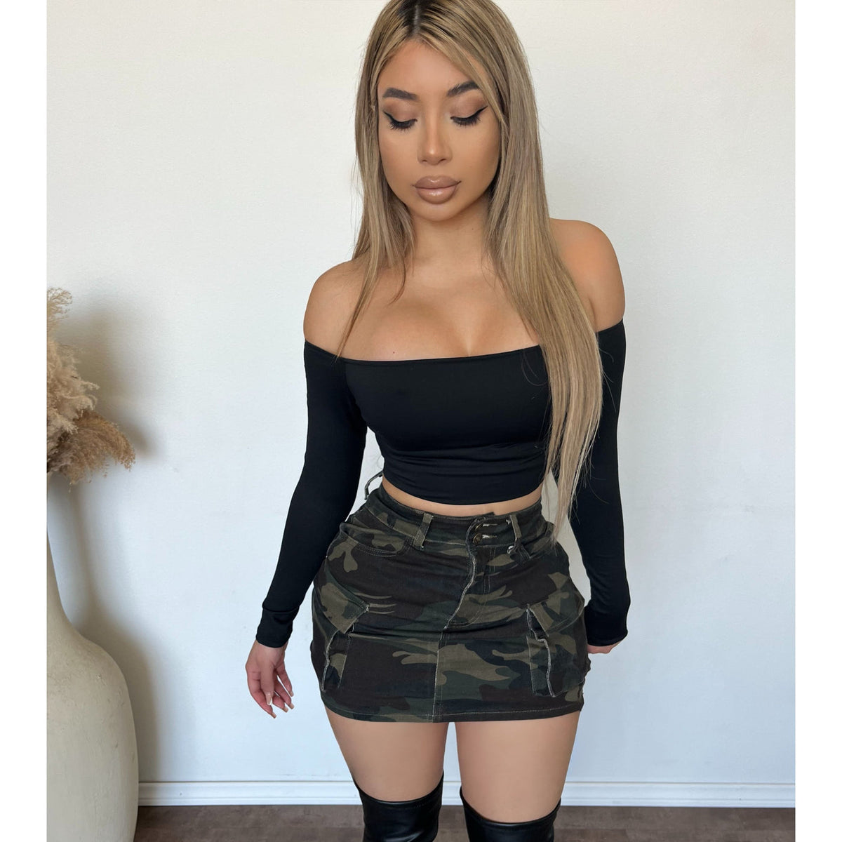 Model in a camo stretch skirt