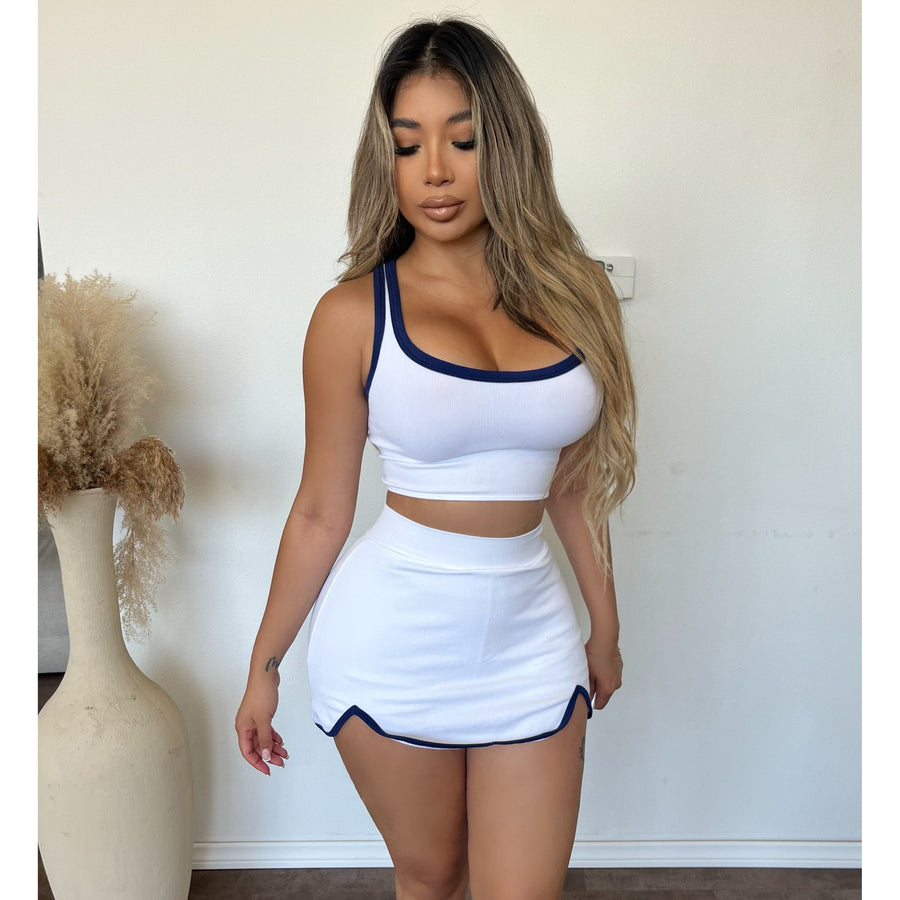 Model in a white top and skort set